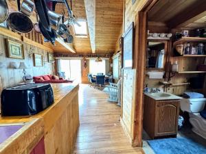 a kitchen and living room in a tiny house at Back of the Moon Lakefront Camp family watersports fire pit 1 dog beach sleeps 8 in Sullivan