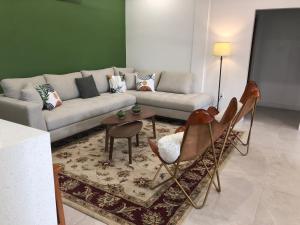 a living room with a couch and a table and chairs at 14 Cedar Entire Property in Dangriga