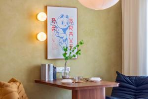 a table with a plant on it next to a couch at The Sun by Stellar ALV in Bayan Lepas