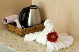 a counter with towels and a tea pot and a flower at Gold Sand Beach Bungalow in Phu Quoc