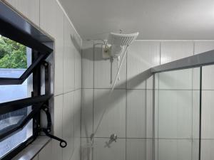a shower with a shower head in a bathroom at CASA SUZENA - Penha SC a 300 metros do Beto Carrero e Praias in Penha +38 photos