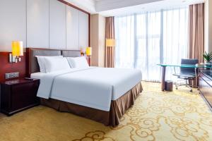Voodi või voodid majutusasutuse Shenzhen Avant-Garde Hotel toas