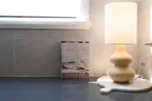 a vase sitting on a table next to a book at Elegant 2-Bedroom Home with Curated Decor & Outdoor Entertaining in Inveresk +27 photos