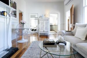 a living room with a couch and a glass table at Elegant 2-Bedroom Home with Curated Decor & Outdoor Entertaining in Inveresk