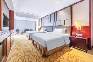 Voodi või voodid majutusasutuse Shenzhen Avant-Garde Hotel toas