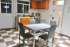 a kitchen with a table and chairs in a room at Apartment, Star Hotel in Zacatlán