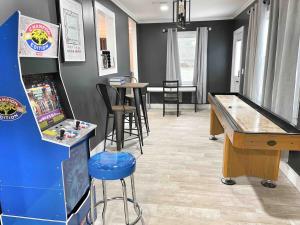 a game room with a pinball machine and a table at Family Retreat Prime Location in Decatur in Decatur