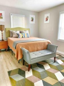 a bedroom with a bed and a bench in it at Family Comfort with Graceful Stays in Decatur