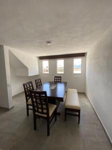 a dining room with a table and chairs and windows at Hotel Estrella Apt B in Zacatlán +21 photos