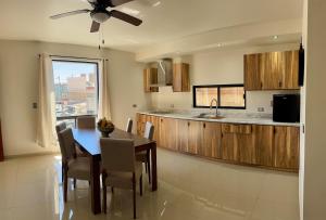 a kitchen with a dining room table and a counter at Mina la Prieta 2 Apartment in Hidalgo del Parral