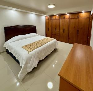 a bedroom with a large bed and wooden cabinets at Mina la Prieta 2 Apartment in Hidalgo del Parral