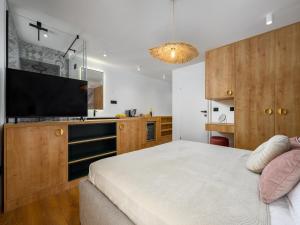 a bedroom with a bed and a flat screen tv at Room in Porec Old Town by Waterfront in Poreč
