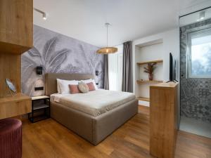 a bedroom with a bed and a desk and a tv at Room in Porec Old Town by Waterfront in Poreč