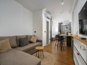 a living room with a couch and a kitchen at Room in Porec by Old Town & Waterfront in Poreč