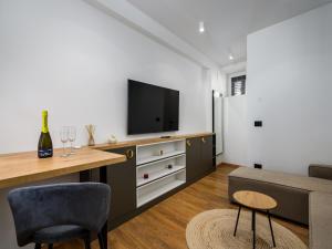 a living room with a tv and a couch at Room in Porec by Old Town & Waterfront in Poreč