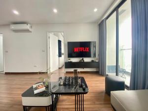 a living room with a table and a tv at SoSa Home in Ha Long +5 photos