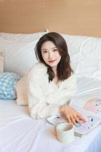 a woman laying on a bed with a book at EUPHORIA丨Quiet Garden Quiet Designer Garden Hotel丨Datang Never Sleeps City Big Wild Goose Pagoda Subway Station Branch丨Near the scenic area in Xi'an