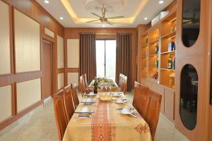 a large dining room with a long table and chairs at UFJ HOTEL Sầm Sơn in Sầm Sơn