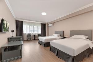 Posteľ alebo postele v izbe v ubytovaní Oak Hotel Chengdu Jiuyanqiao Chuanyin Branch