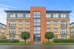 a large brick building with trees in front of it at Cheap modern room in Dublin