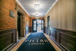 a hallway with a sign that reads the miller london at The Pillar Hotel in London