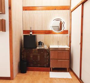 a small bathroom with a sink and a mirror at HAEMIL Hanok in Seoul +23 photos