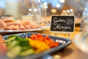 a buffet of food with a sign on a table at Pension Schachner in Schladming