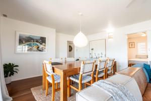 a dining room with a table and chairs at Malolo in Yamba