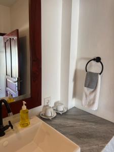 une salle de bain avec un lavabo et un miroir dans l'établissement Uluwatu Stay's Standard Room #3, à Uluwatu 21 autres photos