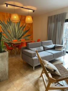 a living room with a couch and a table at Casa Frida in Villa Carlos Paz