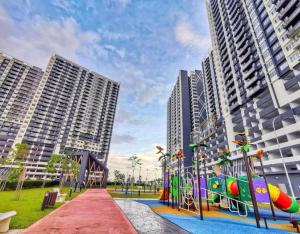 a playground in a park with tall buildings at Cheta homestay in Kajang