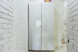 a white refrigerator in a white brick wall at Двухкомнатная евро двушка в самом центре Алматы, 10 минут ходьбы до Арбата #23 in Almaty