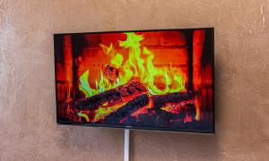 a picture of a fireplace on a wall at Двухкомнатная евро двушка в самом центре Алматы, 10 минут ходьбы до Арбата #23 in Almaty