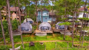 an aerial view of a group of tents in the woods at De Vivre Café & Home in Kon Plong