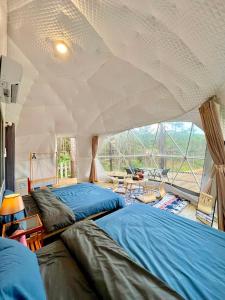 a bedroom with two beds in a tent at De Vivre Café & Home in Kon Plong +37 photos