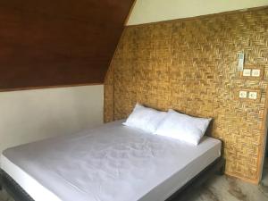 Postel nebo postele na pokoji v ubytování Bello Ethnic Bungalow & Resto
