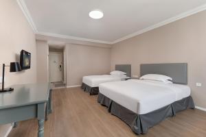 Posteľ alebo postele v izbe v ubytovaní Oak Hotel Chengdu Jiuyanqiao Chuanyin Branch