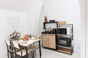 a dining room with a table and a microwave at Ty Kerfany in Moëlan-sur-Mer