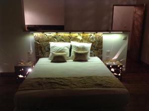 a bedroom with a large bed with lights on it at La Villa Paille en Queue in Saint-Gilles-les-Bains