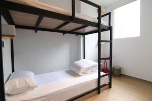 Postel nebo postele na pokoji v ubytování Taipei Sunny Hostel