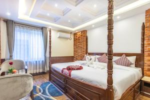 Rúm í herbergi á Amarawati Boutique Hotel