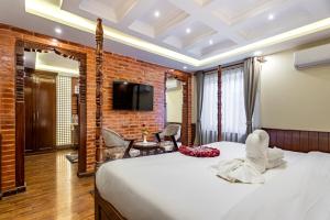 Rúm í herbergi á Amarawati Boutique Hotel