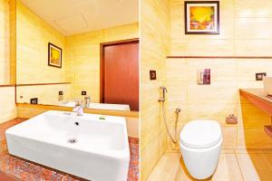 a bathroom with a white sink and a toilet at FabHotel Golden Vista in Bengaluru