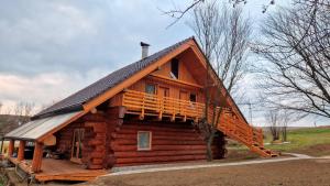 a log cabin with a porch and a deck at Apartmany Nemo in Nemotice