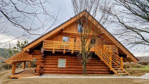 a log cabin with a porch and a deck at Apartmany Nemo in Nemotice +22 photos