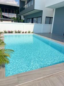 a swimming pool in front of a building at Dream pool villa 5 in Jomtien Beach