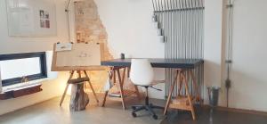 a room with a desk and a table with a chair at Stylish Stay - Steps from Central Festival in Sathani Khlong Rian