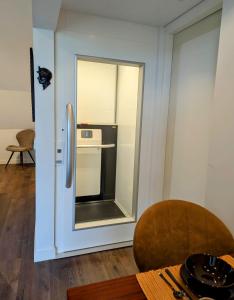 een keuken met een koelkast en een eettafel bij Mijn appartement met sauna en lift in Voerendaal +21 foto's