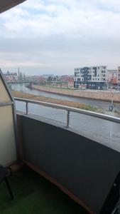 a window with a view of a river and buildings at Nisava rest in Niš
