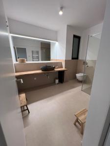 a bathroom with a sink and a toilet and a mirror at Apartments-M4 in Neos Marmaras +71 photos